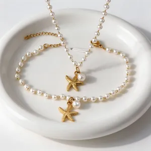 Pearl starfish necklace bracelet set, beach vacation jewelry detail, elegant gold charm design.