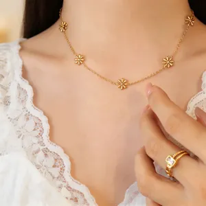 Close-up detail of a delicate gold-plated titanium steel daisy necklace with floral charms.