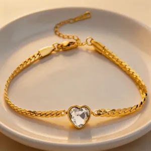 Close-up detail of a gold-tone stainless steel heart-shaped crystal pendant necklace.