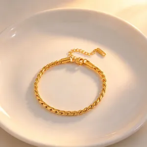 Gold twist chain bracelet detail shot, elegant titanium steel jewelry design closeup view.