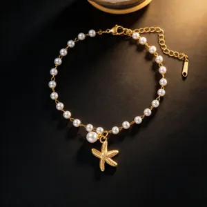 Detailed close-up view of the elegant gold starfish and pearl bracelet with extension chain.