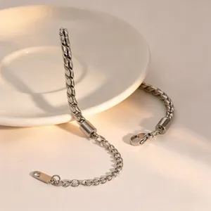 Detailed view of stylish silver-tone metal twist chain bracelet with extension and clasp.