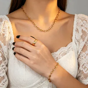 Detailed close-up view of gold titanium steel coffee bean chain necklace, bracelet and ring.