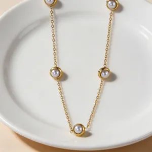 Minimalist gold-tone chain pearl station necklace for women elegant daily jewelry accessory.