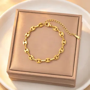 Exquisite gold-plated titanium steel coffee bean chain bracelet detail, minimalist luxury style.