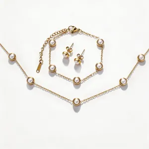 Gold-plated titanium steel pearl necklace bracelet and earrings jewelry set detail view.