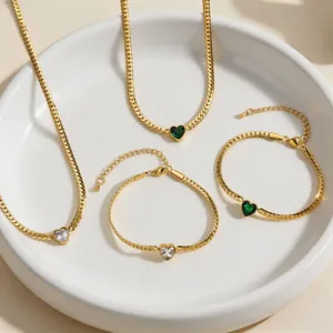 Detail shot of heart-shaped zircon gold chain necklace and bracelet set, elegant jewelry.