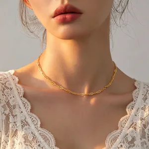 Close-up detail of the minimalist gold chain choker necklace, delicate link design for layering.