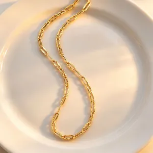 Close-up detail of the gold textured link chain necklace, elegant and minimalist design.