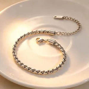 Exquisite metal twist chain bracelet with lobster clasp and extension, elegant detail style.