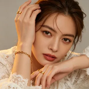 Chic titanium steel gold rings and chain bracelet set for women, elegant jewelry detail shot.