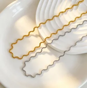 Detailed view of wavy chain stainless steel necklaces in gold and silver finish, minimalist.