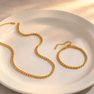 Detailed view of the gold twisted chain necklace and bracelet set, elegant titanium steel jewelry.
