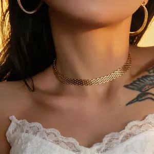 Gold mesh snake chain choker detail, minimalist metallic clavicle necklace close-up view.