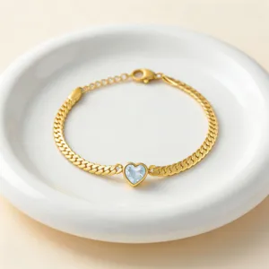 Gold tone heart zircon bracelet detail view, elegant minimalist jewelry accessory.