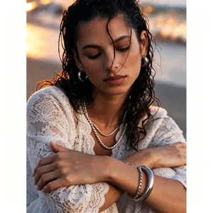 Close-up shot of layered twisted chain necklace and bracelet set, elegant details.