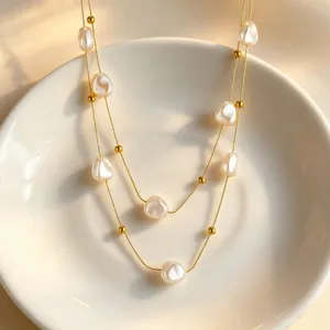 Elegant double layer baroque pearl necklace with gold beads detail, chic clavicle chain.