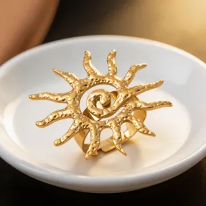 Detailed close-up view of the golden spiral sun metal pendant with delicate hollow design.