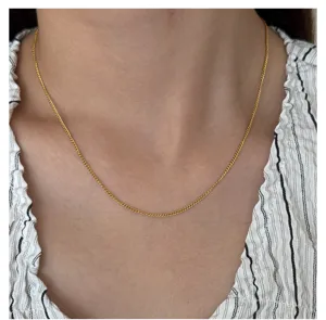 Close-up detail of a delicate gold plated chain necklace, showing exquisite craftsmanship.