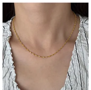 Detail shot of dainty 18k gold plated titanium steel twist rope chain necklace for women.