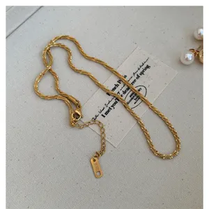 Detail view of 18k gold plated titanium steel snake chain necklace with adjustable extension.