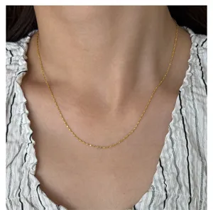 Detail view of dainty 18k gold plated stainless steel thin chain necklace for women.