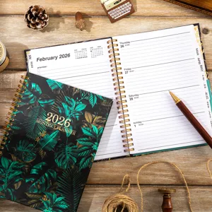 Detailed view of the 2026 tropical green floral planner notebook with open monthly schedule pages.