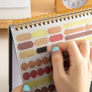Close-up detail of Morandi color planner stickers, spiral bound calendar memo pad page.