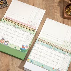 2026 desktop calendar detailed view showing monthly schedule and notes on wooden desk