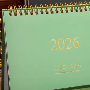 Detailed view of the 2026 Morandi green desk calendar with elegant gold foil typography.