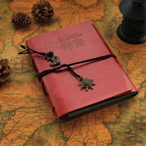 Vintage leather photo album retro journal diary notebook with rope tie and metal charms.