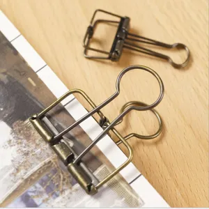 Retro metal hollow binder clips for office and school document organization, durable stationery.