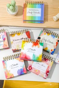 Desktop daily desk calendar with colorful watercolor cover design and 365 days inspirational quotes.