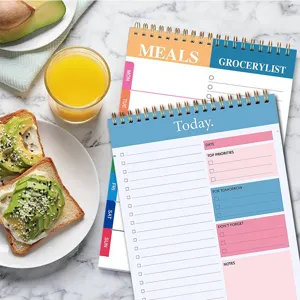 Detailed view of the daily planner and meal notepad with colorful layout and spiral binding.