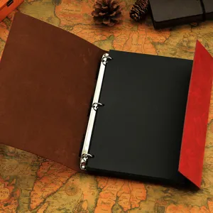 Vintage leather DIY photo album with black inner pages and metal binder rings for memories.