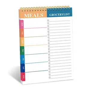 Weekly planner pad detail showing meals and grocery list sections with spiral binding