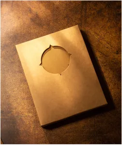 Vintage DIY photo album gift box close-up, retro brown kraft paper cover with hollow cutout.
