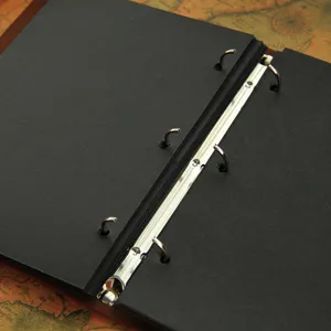 DIY photo album with black pages and metal binder rings, vintage scrapbooking memory book.