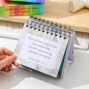Detail shot of English motivational desk calendar with daily inspirational quote page layout.