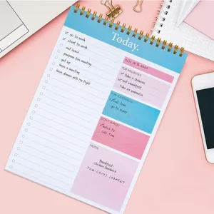 Detailed view of pink daily planner notepad with English schedule layout and ring binding.