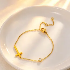 Close-up detail of the gold titanium steel cross bracelet featuring a sparkling single crystal.