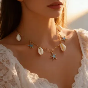 Gold tone seashell and blue starfish charm necklace detail closeup for summer beach resort.