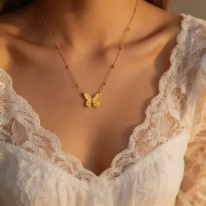 Close-up view of the delicate gold butterfly pendant necklace, showcasing fine chain details.