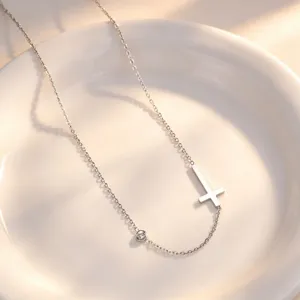 Detailed view of silver titanium steel cross necklace with crystal pendant, elegant style.