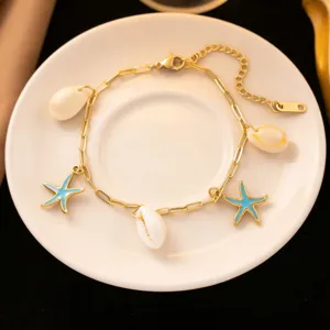 Gold-plated starfish shell necklace with blue enamel charms for summer beach vacation.