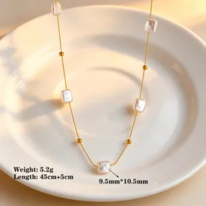Close-up detail of baroque pearl and metallic chain necklace, elegant and delicate design.