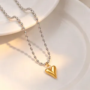 Gold and silver heart bead necklace detail showcasing the elegant metallic peach heart pendant.
