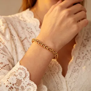 Gold braided chain bracelet detailed view, elegant stainless steel wrist jewelry for women