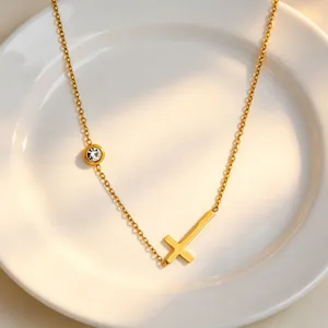 Close up of a minimalist titanium steel gold cross necklace detail, elegant daily jewelry style.