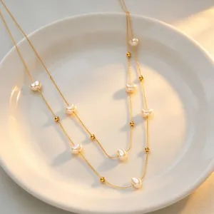 Exquisite double layer pearl necklace featuring baroque pearls and gold beads, elegant jewelry.